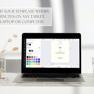 May include: A laptop computer displaying a digital design template for a cocktail party invitation. The template features a blue and white illustration of a cocktail glass with a straw. The laptop screen also shows a color palette with various shades of blue, green, pink, and purple.
