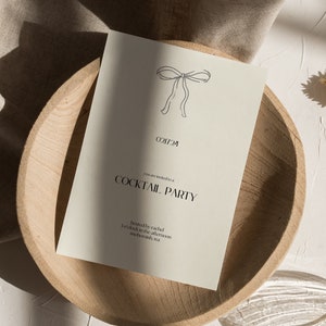 May include: A simple, minimalist invitation card with a hand-drawn bow at the top. The text reads "You are invited to a Cocktail Party" and "Hosted by Rachel 7 o'clock in the afternoon somewhere, usa"