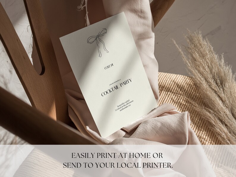 May include: A white card with a black bow illustration and the text "Cocktail Party" printed on it. The card is sitting on a light brown surface.