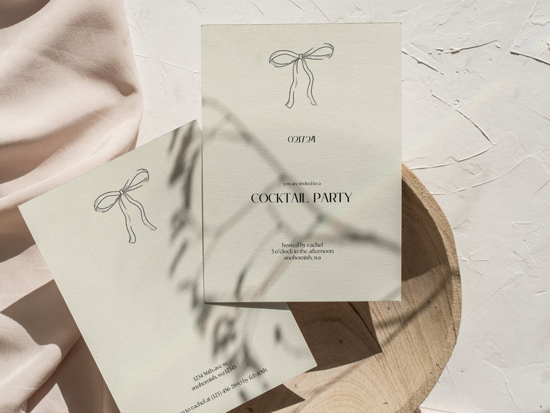 May include: A beige invitation card with a simple line drawing of a bow at the top. The text "021724 COCKTAIL PARTY hosted by rachel 3 o'clock in the afternoon anohombh, wa" is printed in black.