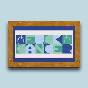May include: A framed cross-stitch design with a blue background and green and blue lettering that reads "F**K CANCER" with a middle finger symbol on either side of the word "F**K".