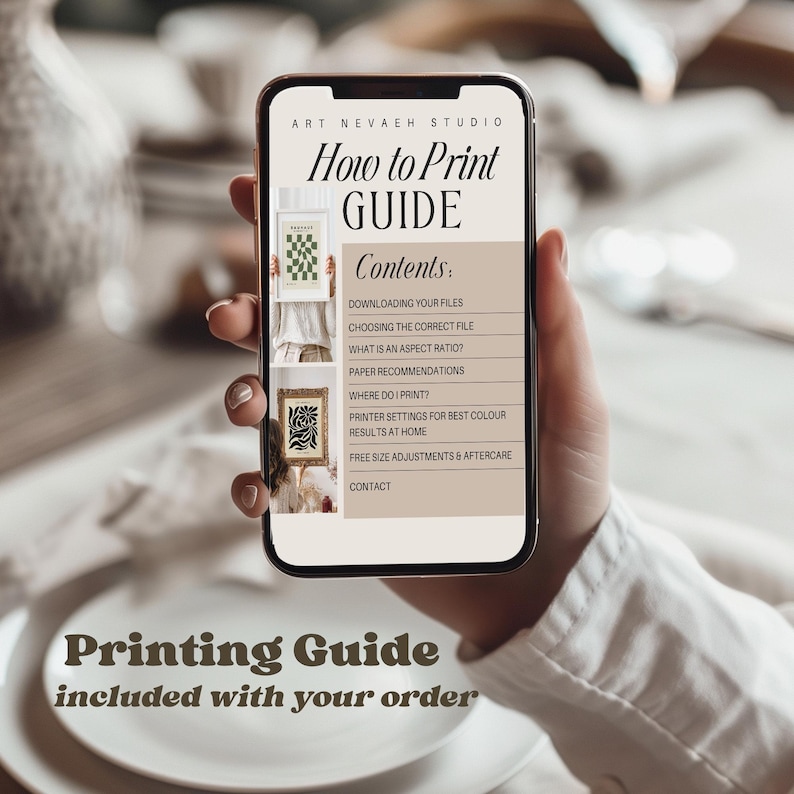 A person's hand holding a smartphone displaying a guide titled "How to Print Guide" from the Art Nevada Studio.