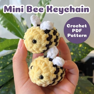 May include: Two handmade mini bee keychains. The bees are yellow with black stripes and white wings. The text "Mini Bee Keychain" is at the top of the image. A purple circle with the text "Crochet PDF Pattern" is on the right.
