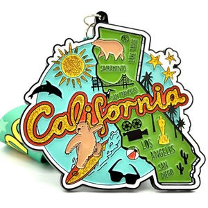 May include: A green, yellow, and blue enamel pin shaped like the state of California. The pin features a bear surfing, a sun, a palm tree, and the words "California", "San Francisco", "Los Angeles", and "San Diego".