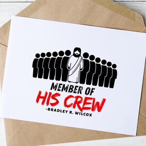 May include: A white greeting card with the text "MEMBER OF HIS CREW" in black and red, featuring a graphic of a figure with a beard and a group of silhouettes. The card is inside a brown envelope.