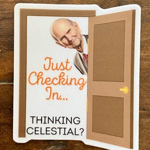 May include: A sticker with a cartoon image of a man peeking through a door. The text on the sticker reads "Just Checking In... Thinking Celestial?"