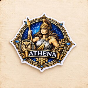 May include: A circular sticker featuring a depiction of Athena wearing a helmet and holding a spear. An owl is positioned to the left. The design includes a blue lightning background, gold laurel leaves, and blue gems. A banner at the bottom reads ATHENA.