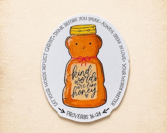 May include: An oval sticker featuring a golden honey bear bottle with a yellow cap and a red string bow. The label reads Kind words are like honey. The border text says THINK BEFORE YOU SPEAK. ALWAYS SPEAK IN LOVE. YOUR WORDS MATTER. LET YOUR WORDS REFLECT CHRIST. PROVERBS 16:24.