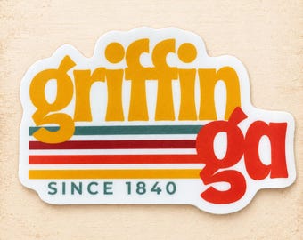May include: A die-cut sticker featuring the yellow text 'griffin' above the red text 'ga' and the teal text 'SINCE 1840'. The design includes horizontal stripes in teal, dark red, orange, and yellow, all set against a white background.