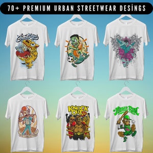 May include: Six white t-shirts with different graphic designs. The designs include a monster with the text "Catch You", a green monster playing soccer, a skull with wings and flowers, a man with a beer and the text "Old Time Batter", a gorilla boxing with the text "Knock Out", and a monkey swinging a baseball bat with the text "Home Run".