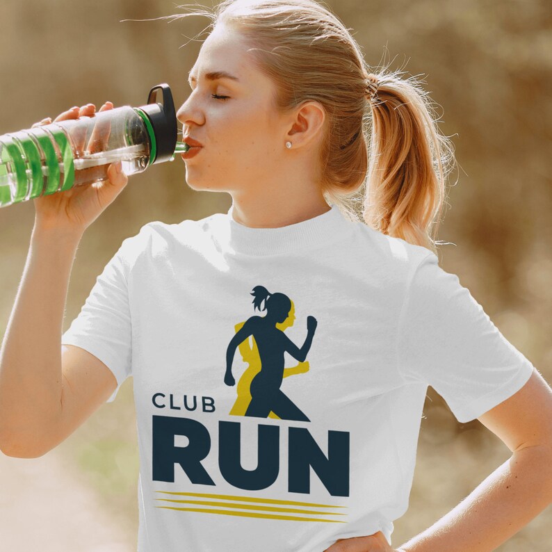 May include: White t-shirt with a blue and yellow graphic design. The graphic features a silhouette of a runner and the text "CLUB RUN".