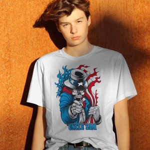 May include: White t-shirt with a graphic of Uncle Sam as a skull wearing a top hat and holding an American flag. The graphic is in red, white, and blue colors. The text "Uncle Sam" is printed below the graphic.