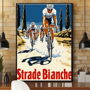 May include: A framed poster featuring a group of cyclists riding on a dirt road with tall cypress trees in the background. The lead cyclist wears a white jersey and sunglasses. The text Strade Bianche is printed in large red letters at the bottom.