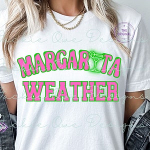 May include: A white t-shirt with the text "Margarita Weather" in pink letters with a green outline. A green margarita glass with a pink drink is above the text.