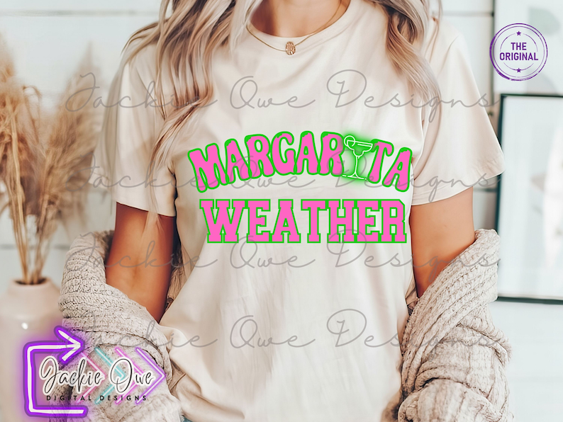 May include: A white t-shirt with the text "Margarita Weather" in pink letters with a green outline. The text is in a retro font style.