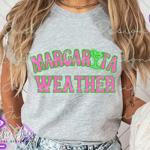 May include: A gray t-shirt with the text "Margarita Weather" in pink letters with a green outline. A margarita glass icon is above the word "Margarita".