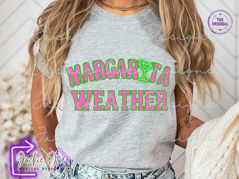 May include: A gray t-shirt with the text "Margarita Weather" in pink letters with a green outline. A margarita glass icon is above the word "Margarita".
