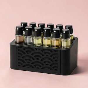 May include: A set of three ceramic mugs with a speckled, matte finish. The mugs are in shades of cream, light gray, and dark gray. Each mug has a simple, minimalist design and a rounded handle.