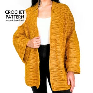 May include: Mustard yellow crochet cardigan with wide sleeves. The image includes the text "CROCHET PATTERN instant download". The cardigan is open in the front and appears to be handmade. The garment is worn over a white top and black pants.