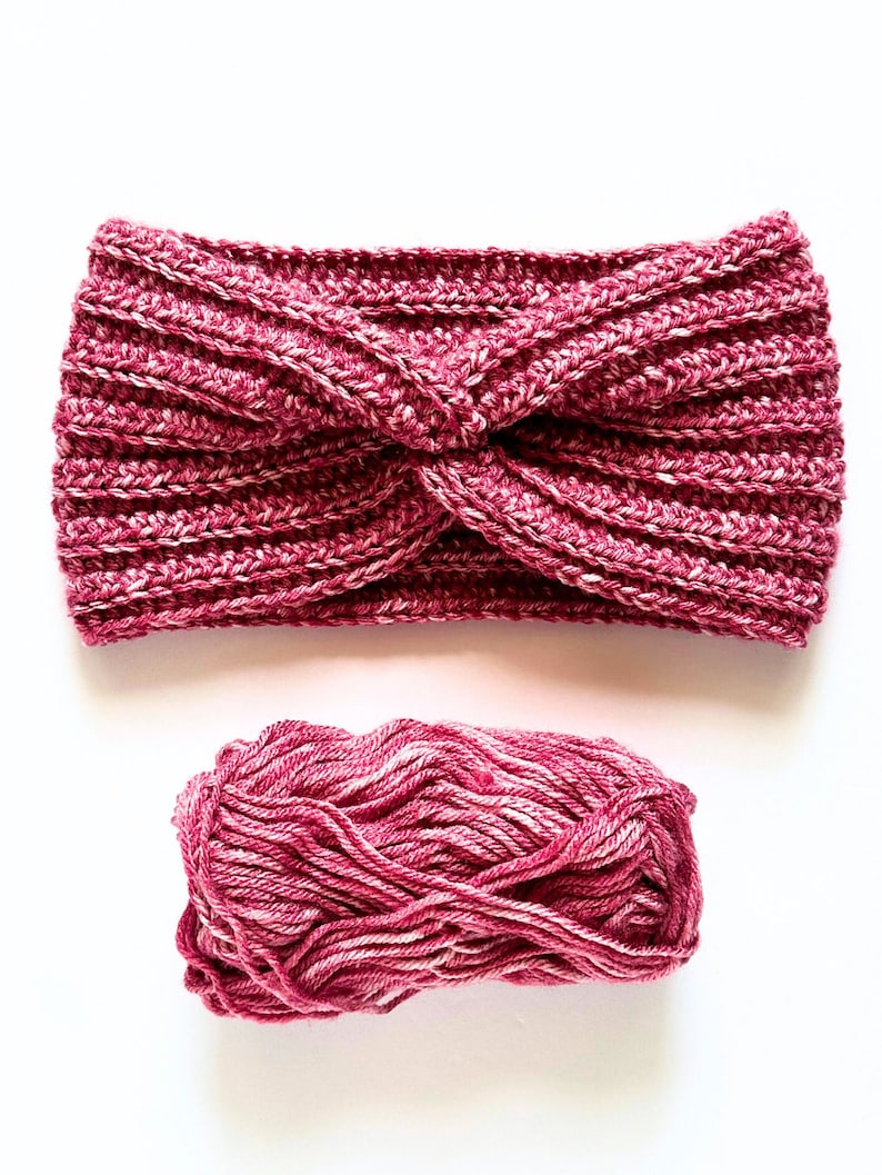 May include: A pink and white yarn headband with a twisted knot design. A ball of pink and white yarn is also shown.