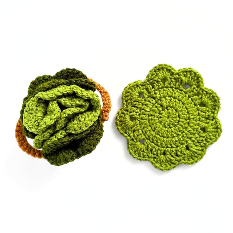 May include: Two crocheted green and orange coasters. One coaster is a round shape with a scalloped edge. The other coaster is a round ball shape.
