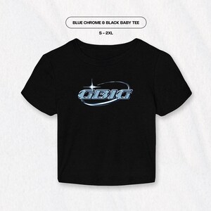 May include: Black baby tee shirt with a blue chrome graphic of the word "GEBIG" in a circle with a star above it. The text "BLUE CHROME & BLACK BABY TEE" and "S - 2XL" are printed above the graphic.