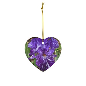 May include: A purple and white iris flower with a yellow center, printed on a heart-shaped ceramic ornament.