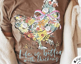 May include: A brown t-shirt with a floral design of a chicken with a pink bow. The text "Life is better with chickens" is printed in blue below the chicken.