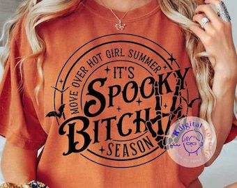 May include: Orange t-shirt with a black circle graphic that says "Move Over Hot Girl Summer + It's Spooky Bitch + Season". The graphic also includes a skeleton hand and bats.