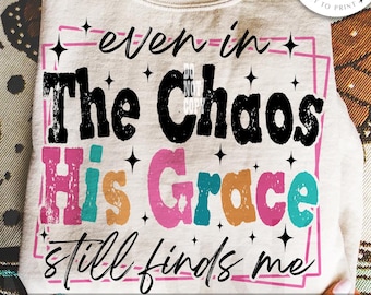 May include: A beige sweatshirt with the text "even in The Chaos His Grace still finds me" in black, pink, teal, and orange. The design includes a pink square and small black star accents. A digital download.