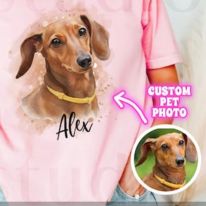 May include: A pink t-shirt featuring a watercolor-style illustration of a dachshund with a yellow collar and the name "Alex". The shirt also has the text "CUSTOM PET PHOTO" and "digital download".