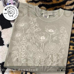 May include: Sage green t-shirt featuring a detailed white floral design. The design includes various flowers and foliage. The words "digital download" are at the bottom of the shirt. The shirt is from Kstudio.