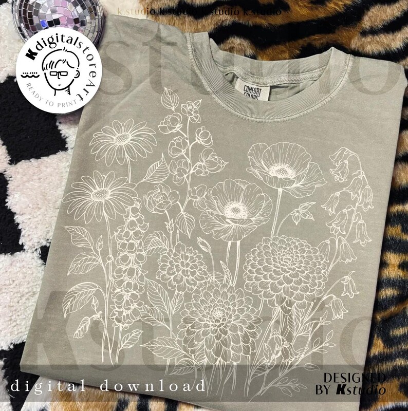 May include: Sage green t-shirt featuring a detailed white floral design. The design includes various flowers and foliage. The words "digital download" are at the bottom of the shirt. The shirt is from Kstudio.