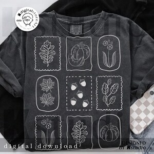 May include: Dark gray sweatshirt featuring nine white line drawings of fall-themed elements, including leaves, pumpkins, acorns, and flowers. The words "digital download" are printed at the bottom. The design is by kstudio.