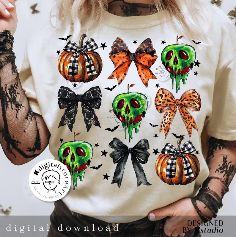 May include: Cream-colored t-shirt featuring Halloween-themed graphics. The design includes pumpkins, bows, and green apple skulls. The words "digital download" and "designed by studio" are printed on the shirt.