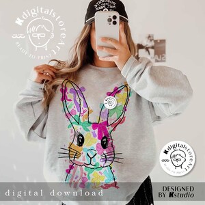 May include: A gray sweatshirt with a colorful bunny rabbit design. The bunny is made up of a variety of colorful bows. The sweatshirt has the text "digitalstoreart" and "ready to print" on it.