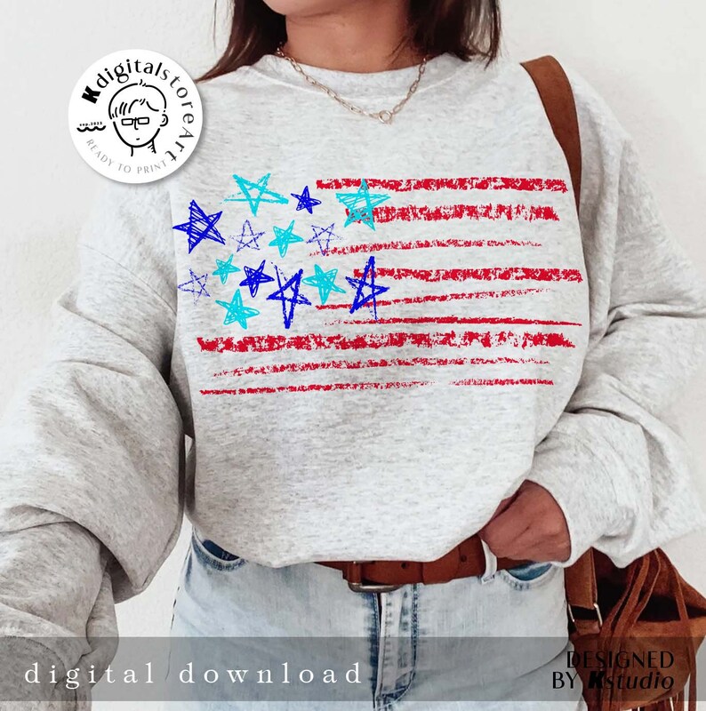 May include: A gray sweatshirt with a red, white, and blue American flag design. The flag is made up of red stripes and blue stars. The stars are drawn in a childlike style.