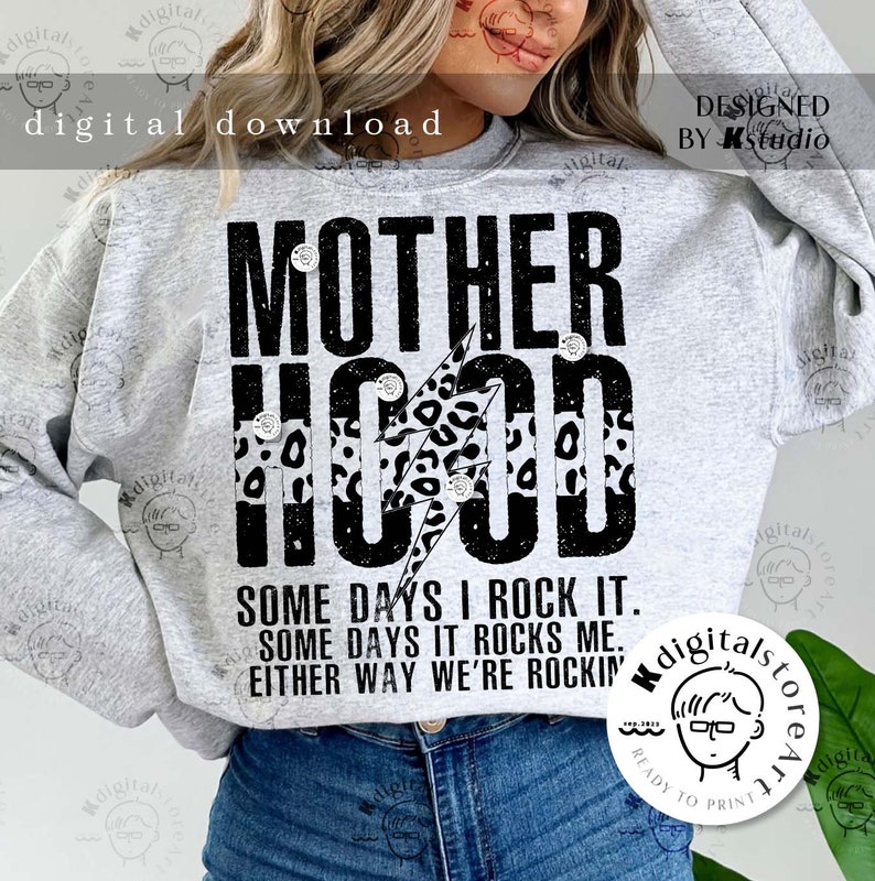 May include: A gray sweatshirt with the text "MOTHERHOOD" in black with a black lightning bolt and leopard print design. The text "SOME DAYS I ROCK IT. SOME DAYS IT ROCKS ME. EITHER WAY WE'RE ROCKIN'" is printed below the main text.