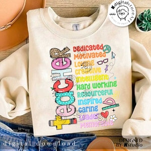 May include: A beige sweatshirt with a colorful graphic design that says "Teacher" with a list of words describing a teacher, such as "dedicated", "motivated", "loving", "creative", "intelligent", "hard working", "resourceful", "inspired", "caring", "grade", and "memorable".