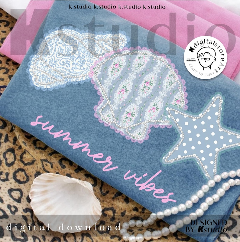 May include: A denim blue fabric with seashell, cloud, and starfish designs, embellished with lace and pearls. The text "summer vibes" is in pink. A seashell and a pearl necklace are also visible.