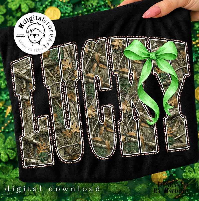 May include: Black t-shirt with the word "LUCKY" in large, bold letters. The letters are filled with a camouflage pattern and outlined in white. A green bow is attached to the right side of the word. The words "digital download" are at the bottom.