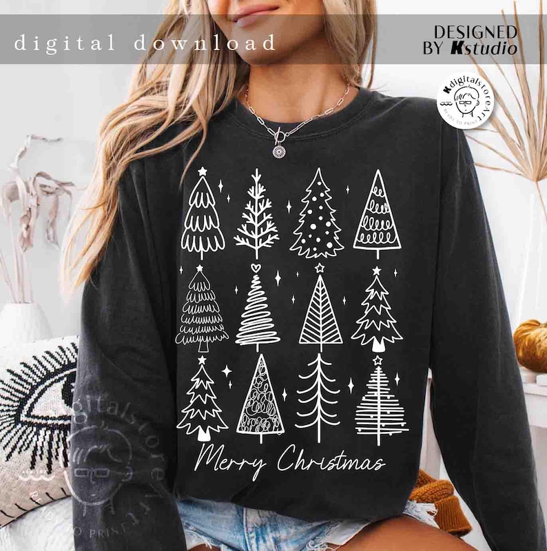 May include: Black long-sleeve sweatshirt featuring a white graphic of various Christmas trees. The text "Merry Christmas" is below the trees. The words "digital download" and "designed by Kstudio" are also visible.
