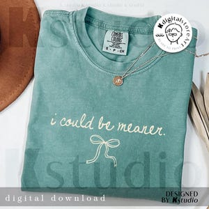 May include: A teal Comfort Colors t-shirt with the phrase "i could be meaner" and a bow graphic. A silver necklace with a pendant is on the shirt. The words "digital download" and "designed by kstudio" are at the bottom.