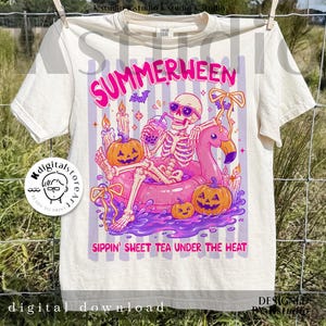 May include: Cream-colored t-shirt with a colorful graphic. The design features a skeleton wearing sunglasses, relaxing on a pink flamingo float, and drinking a beverage. Pumpkins and candles surround the skeleton. Text reads "SUMMERWEEN" and "SIPPIN' SWEET TEA UNDER THE HEAT."