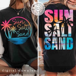 May include: Black t-shirt with a colorful graphic design that says "Sun Salt Sand" in a circle with palm trees. The back of the shirt has the same text in a vertical design with a sunset and palm trees.