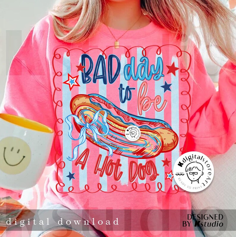 May include: Pink sweatshirt with the text "BAD day to be A Hot Dog" and a graphic of a hot dog. The design includes red, white, and blue stars and stripes. The words "digital download" are at the bottom.