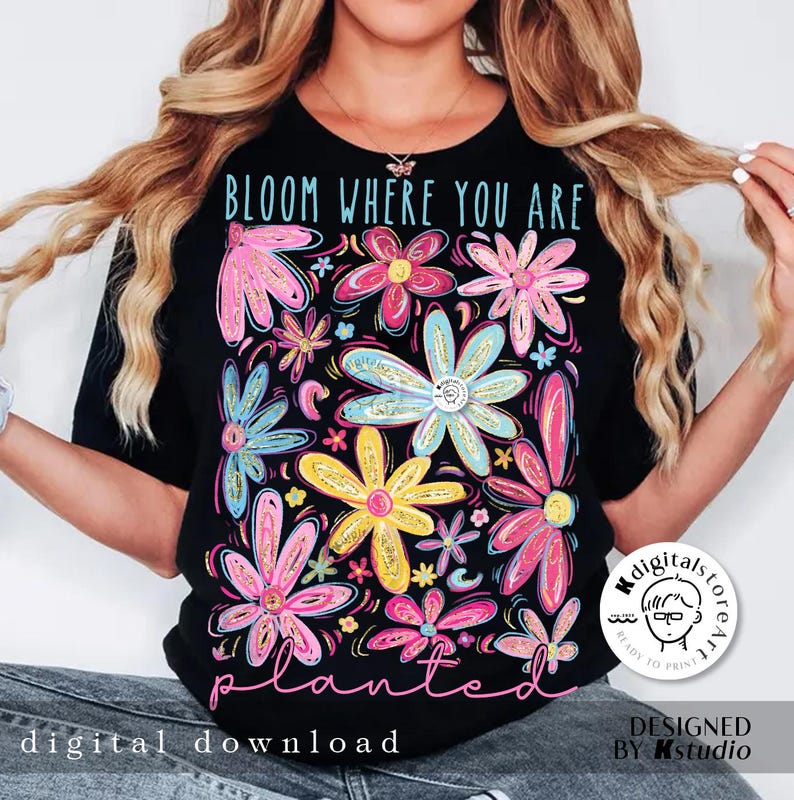 May include: Black t-shirt with a floral design and the text "Bloom Where You Are Planted".