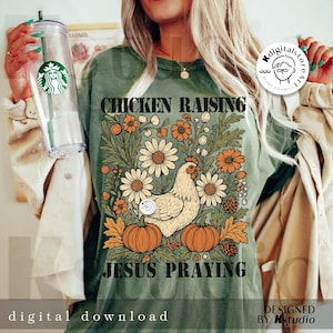 May include: Olive green t-shirt with the text "CHICKEN RAISING JESUS PRAYING". The shirt features a floral design with daisies, pumpkins, and a hen. The words "digital download" are at the bottom.