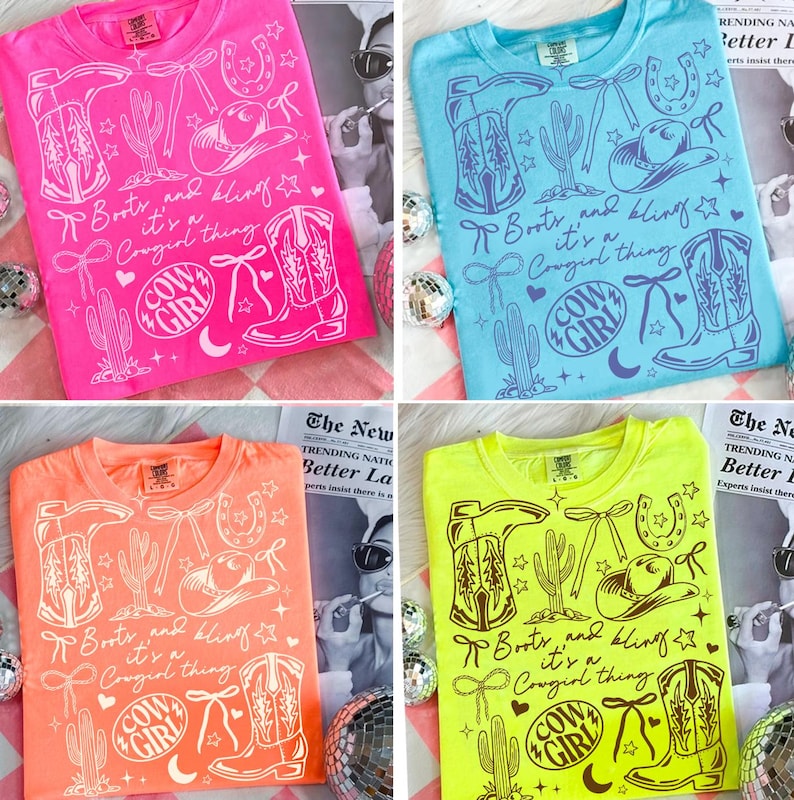 May include: Four t-shirts in pink, blue, orange, and neon green, each with a white graphic. The graphic includes cowboy boots, a cowboy hat, a horseshoe, and the text "Boots and bling it's a Cowgirl thing" and "Cow Girl".