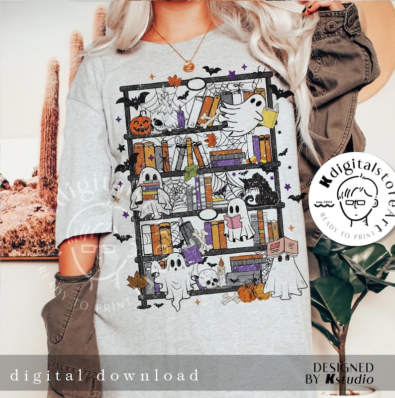 May include: A light gray t-shirt featuring a Halloween-themed bookshelf design. The design includes ghosts reading books, pumpkins, bats, spiderwebs, and autumn leaves. The words "digital download" are printed at the bottom of the shirt.